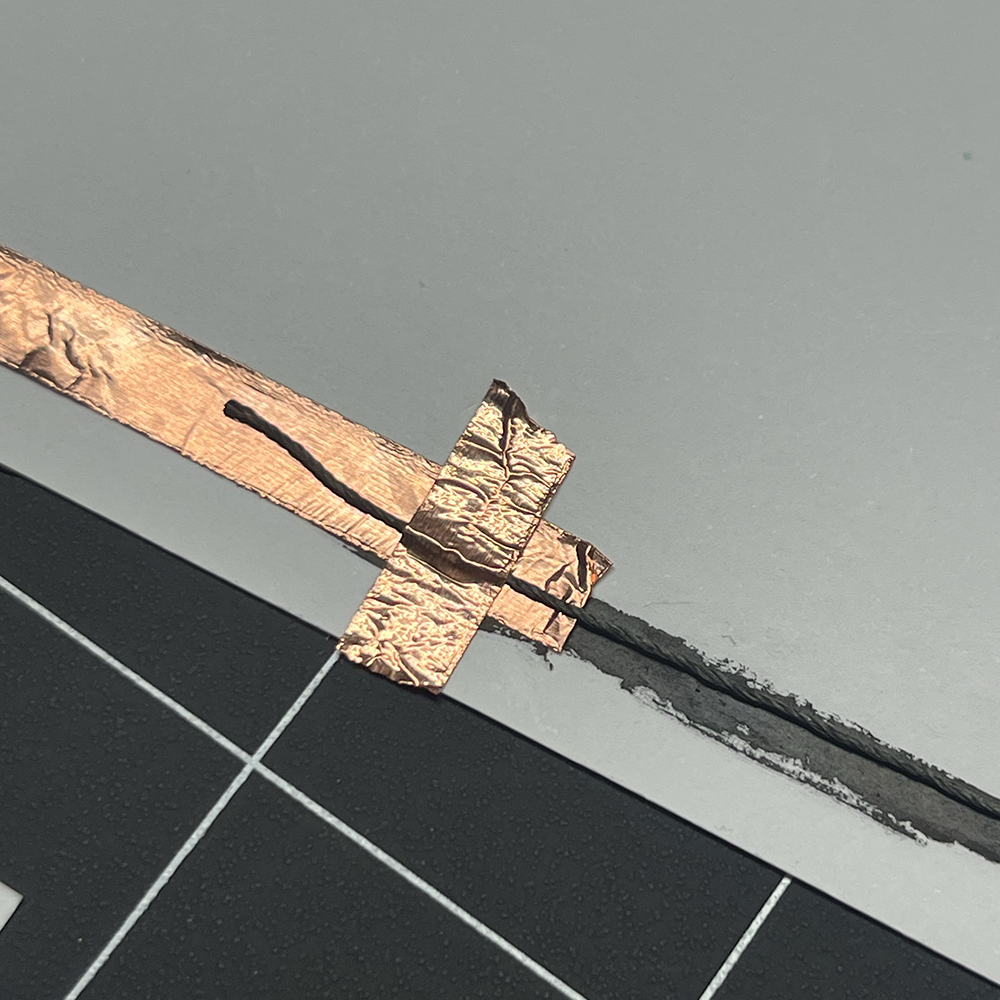 Making test of low voltage electricity using metal button close in detail #4.